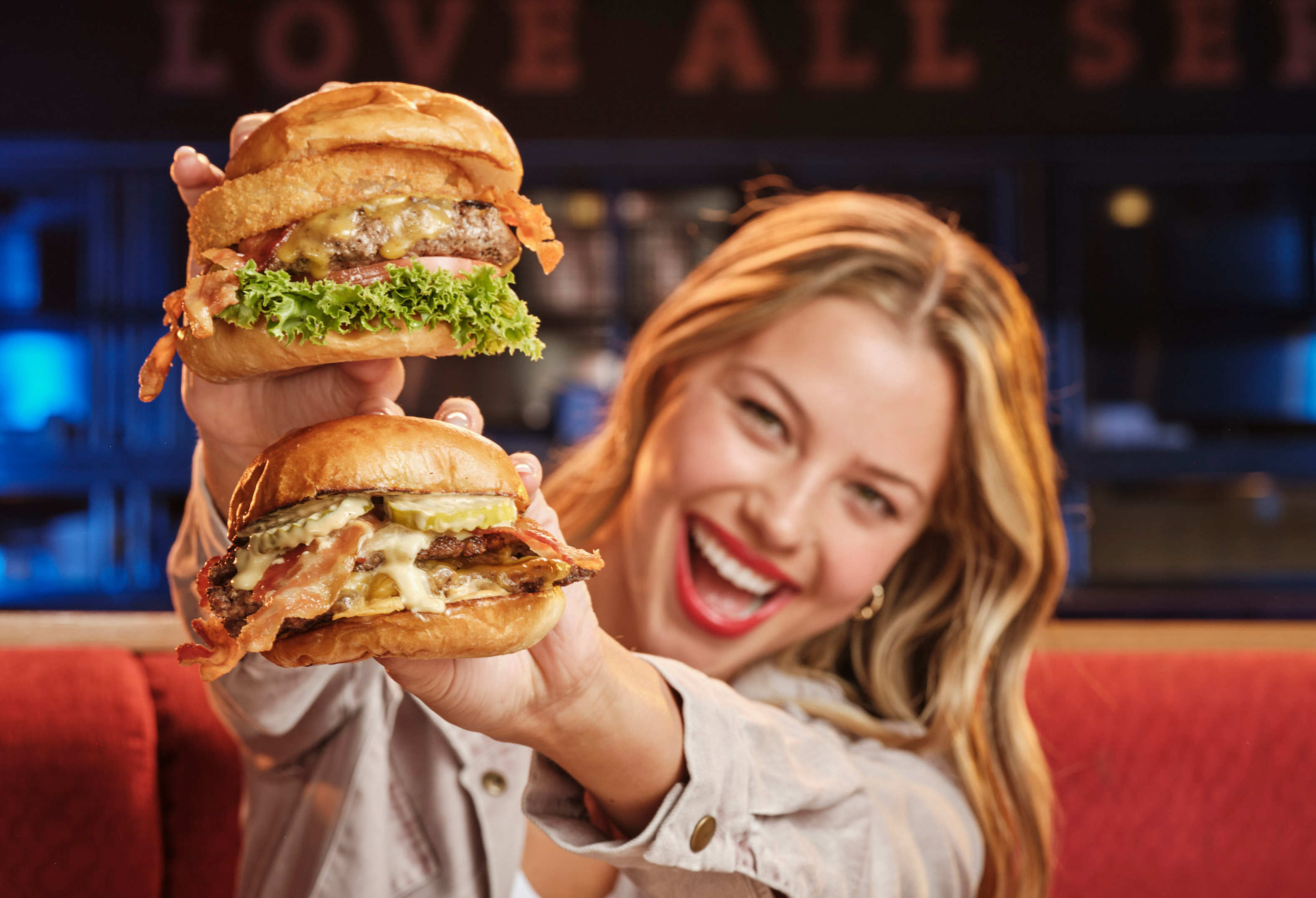 Girl holding two burgers